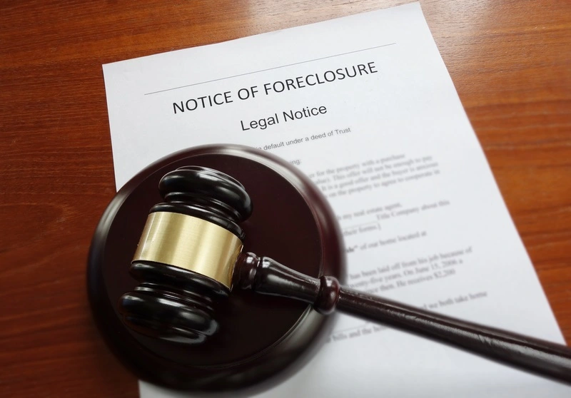 Judge's gavel sitting on top of a foreclosure notice